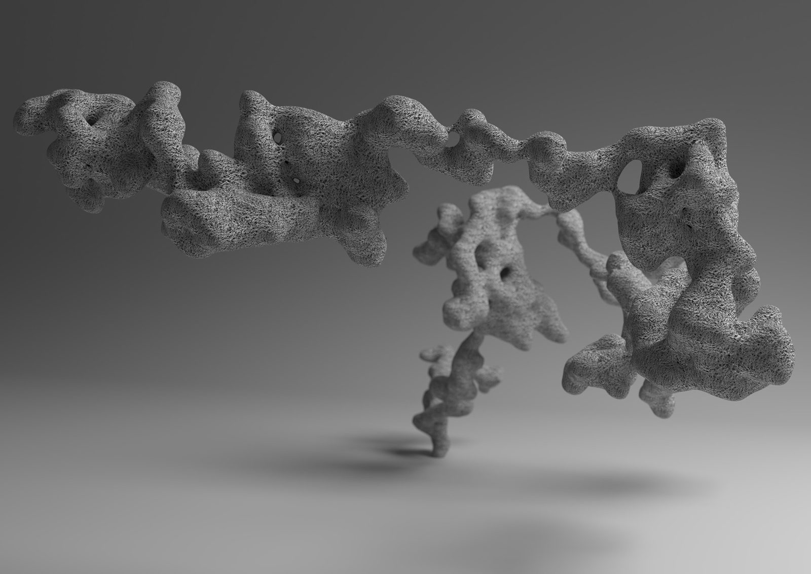 An accreted form of fused irregular masses lying horizontally on a pale grey ground