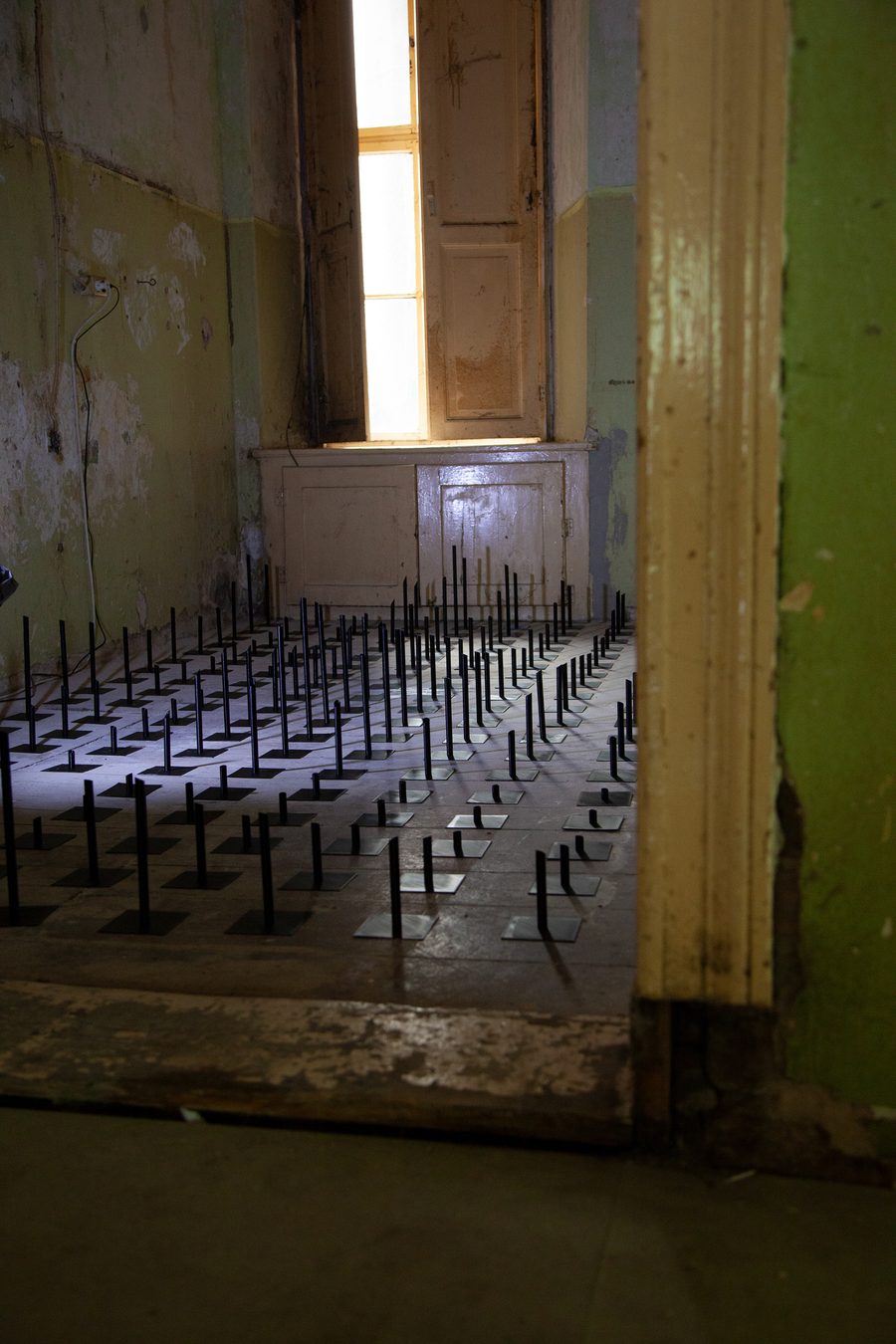 The same room and window, the field running to the far wall
