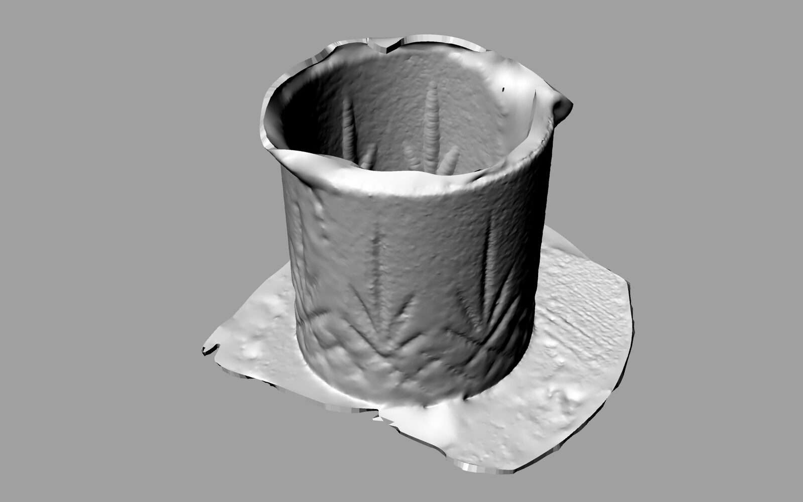 A photogrammetric scan of a cup rendered as a grey mesh, its walls buckled, sitting on a torn scanned plane